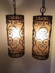 Matching Pair Of Spanish Revival Wrought Iron Pendant Lamps Amber Inserts. Fixed Price $285.00.